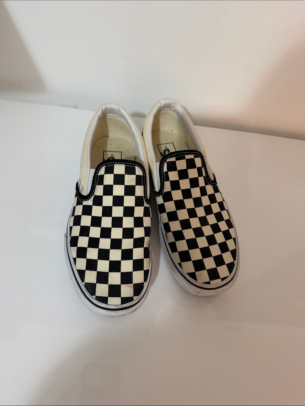 Vans Black and Cream Checkerboard Slip-On Sneakers